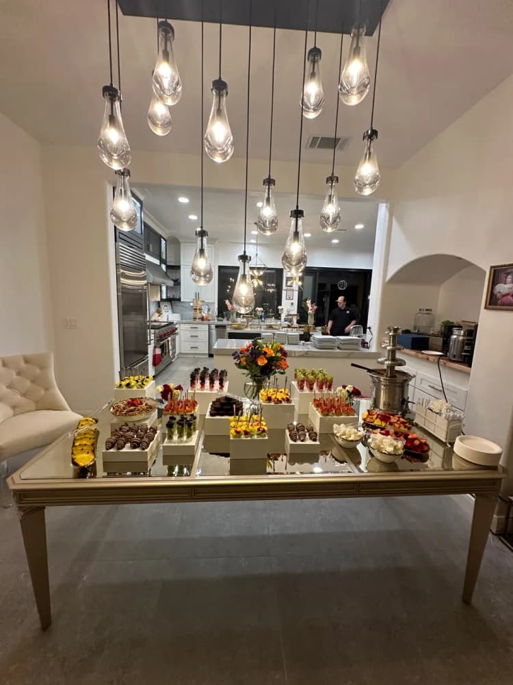 Catered dessert table with fruit and chocolate